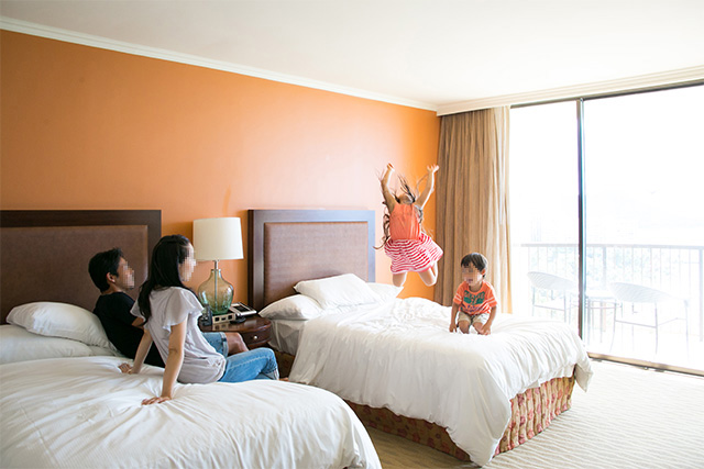 ホテルの客室でくつろぐ家族（ハワイ）