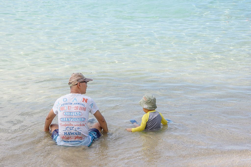 ハワイのビーチで遊ぶ親子
